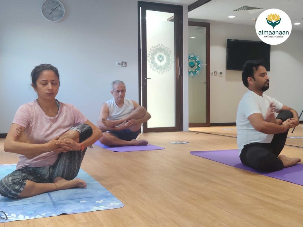Adults doing yoga at Atmaanaan Wellness Centre, Dubai