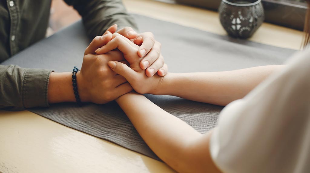 Man and woman holding hands forging a stronger relationship.