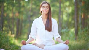 Woman practicing breathwork and grounding to calm overthinking and reset the nervous system naturally.